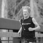 Sequim Gazette photo by Michael Dashiell / Connor Goff of Sequim grimaces as he nears the finish line at the Railroad Bridge Run 5k at Railroad Bridge Park on April 22. Goff finished in 19:51.