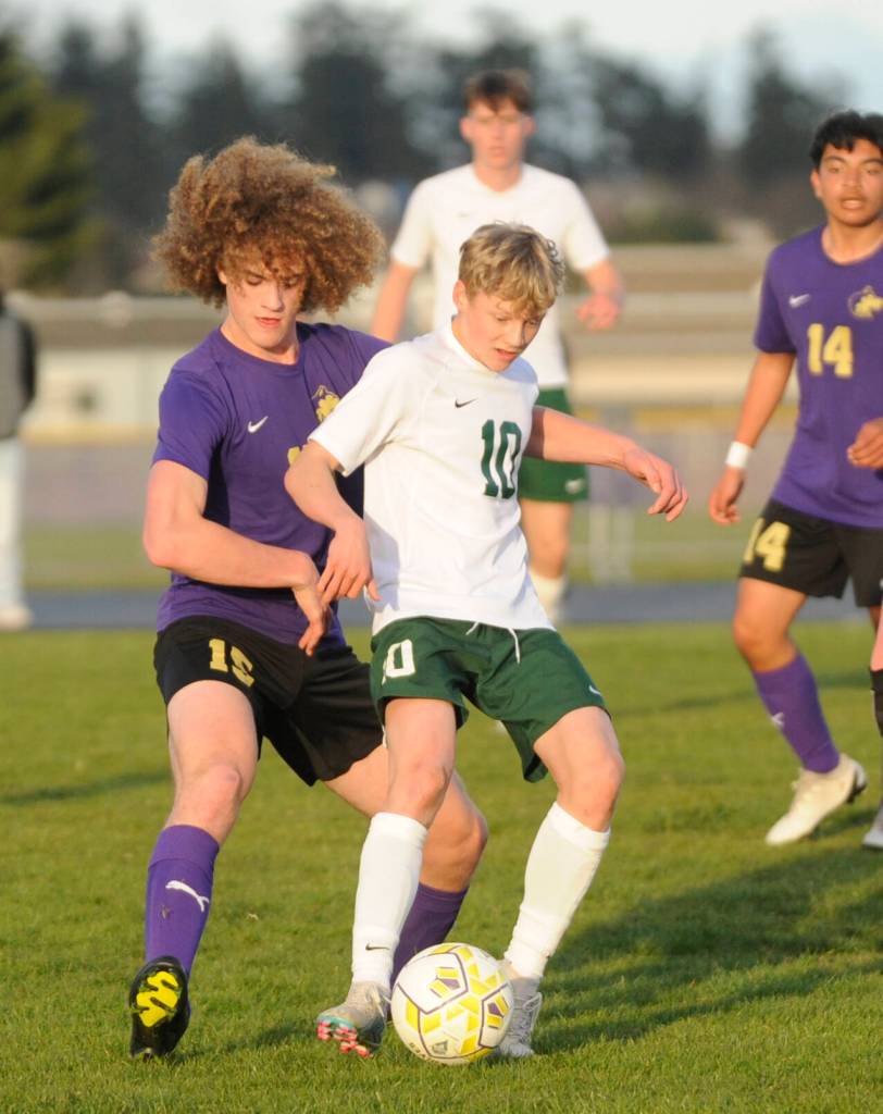 Sequim Gazette photo by Michael Dashiell / Sequims Sam Stewart, left, and Port Angeles Matthew Miller vie for the ball in an April 18 Olympic League game.