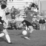 Sequim Gazette photo by Michael Dashiell / As Port Angeles Keane McClain (6) and David Hannes Spieker (9) look on, Sequims Mekhi Ashby looks for an open teammate in the first half of SHSs 1-0 win over the Roughriders on April 18.