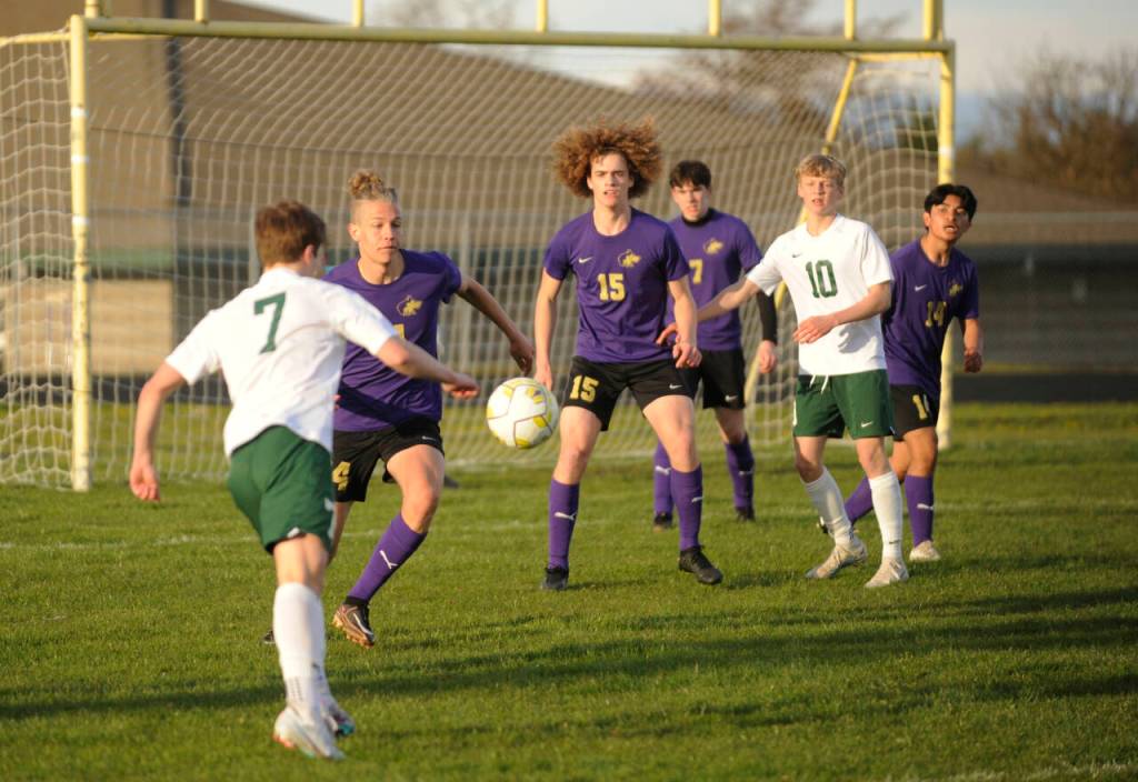 Sequim Gazette photo by Michael Dashiell / Port Angeles Kaleb Gagnon, left, looks to put a shot on goal in an April 18 game in Sequim, as Wolves (from left) Jack Henninger (24), Sam Stewart (15), Colin Feik (7) and Evan Cisneros (14) defend the play.