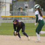 Sequim shortstop Hanna Bates, left, keeps an eye on Port Angeles baserunner Lily Halberg in the Wolves 7-6 home win over Port Angeles on April 18.