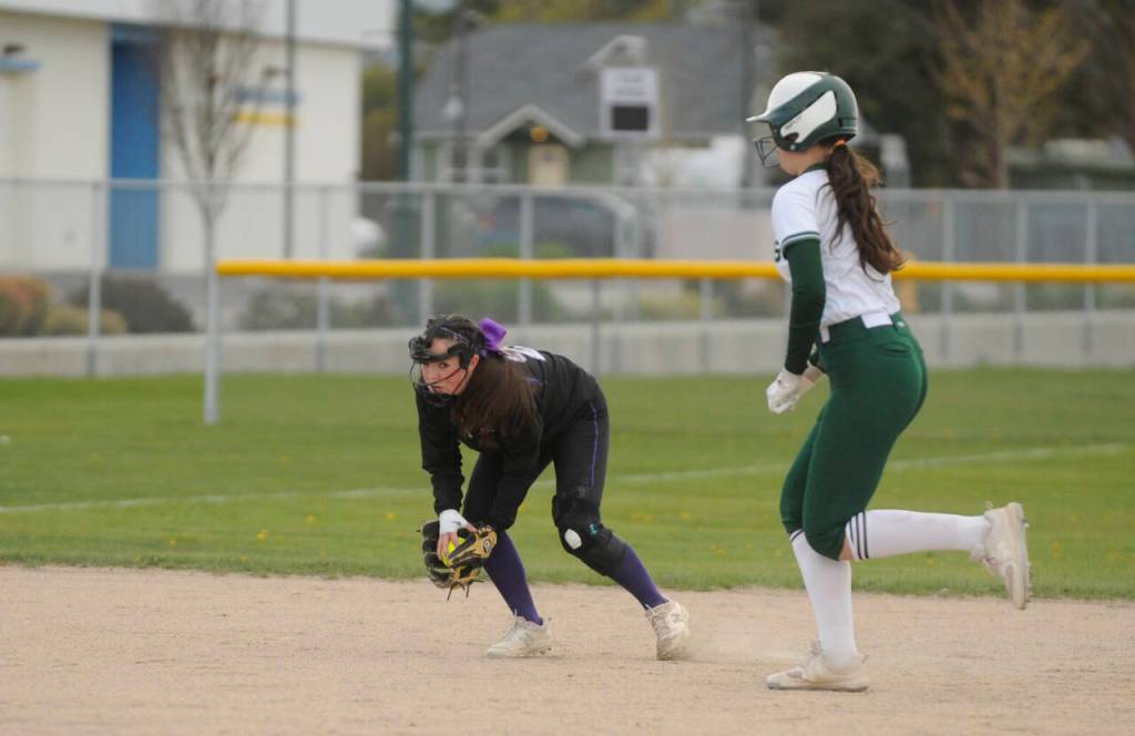 Sequim shortstop Hanna Bates, left, keeps an eye on Port Angeles baserunner Lily Halberg in the Wolves 7-6 home win over Port Angeles on April 18.
