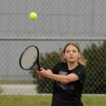 Sequim Gazette photo by Michael Dashiell / Sequims No. 2 singles player Calleigh Thompson returns a shot in a match against Olympic on April 21. Thompson edged Trojan Emlyn Coulter, 7-6 (7-4) and 6-2.