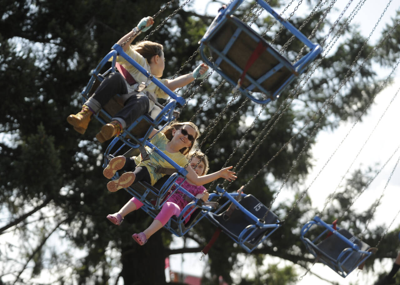Sequim Gazette file photo by Michael Dashiell
From left, Kiari Latson, Mallory Hartman and Annelisa Rosenkranz enjoy a ride at the Clallam County Fair in 2019.