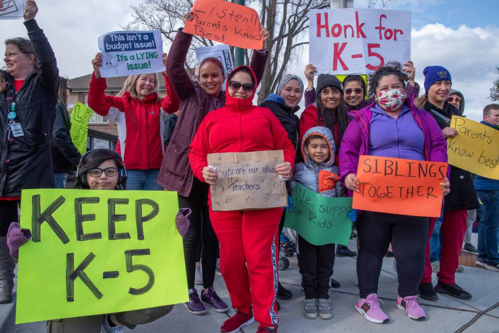 Sequim Gazette photo by Emily Matthiessen
More than 100 adults and children on April 17 protest the Sequim School Boards decision to reconfigure the districts two elementary schools. Sorayao Cogorno-Frutos (kneeling) said she attended Helen Haller Elementary School and would like children to have a similar K-5 grade-level experience.
