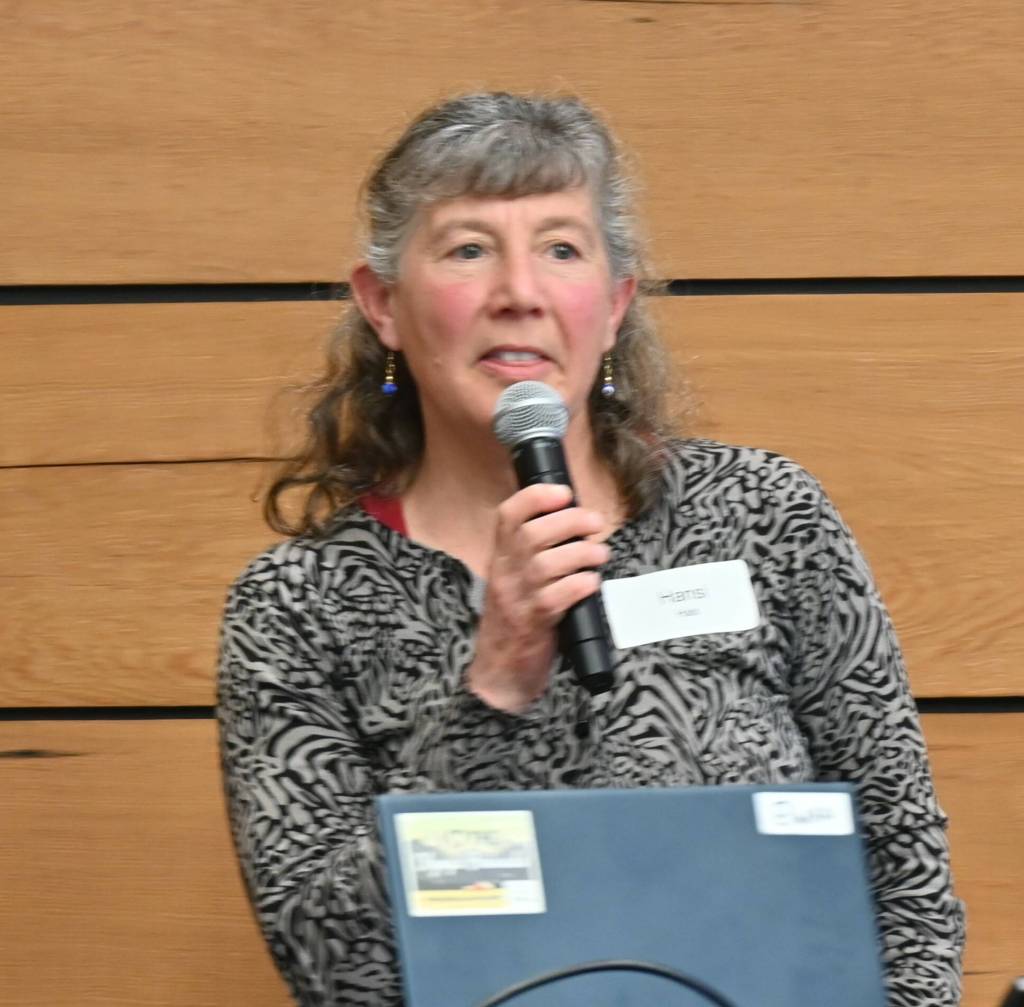 Sequim Gazette photo by Michael Dashiell / Hansi Hals, Natural Resources director for the Jamestown SKlallam Tribe (lower left), accepts the North Olympic Land Trusts Out Standing in the Field award for the Dungeness River Management Team at the Land Trusts annual conservation breakfast on April 21.