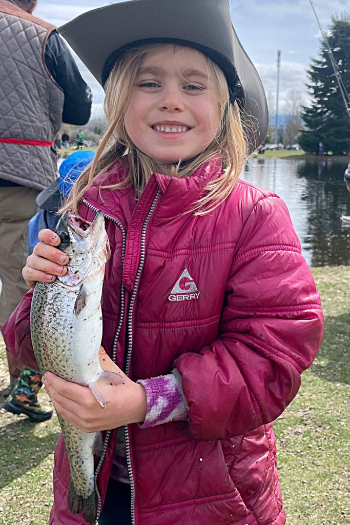 Five-year-old Cora Svik holds up her first ever catch at Kids Fishing Day on April 22. It was her familys first time at the event, too.