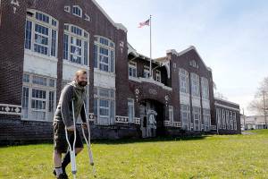 David Brownell, executive director of the North Olympic History Center, stands in front of the historic Lincoln School at Eighth and C streets in Port Angeles on Tuesday. The NOHC is hoping to divest itself of the school building and has issued a request for proposal on what to do with the structure. (Keith Thorpe/Peninsula Daily News)