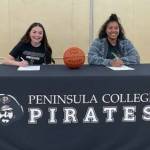 Photo courtesy of Peninsula College / Sequim High School seniors Hannah Bates, left, and Jelissa Julmist sign letters of intent in April to play basketball for Peninsula Colleges Pirates for the 2023-24 season.