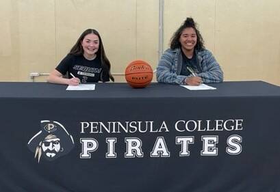 Photo courtesy of Peninsula College / Sequim High School seniors Hannah Bates, left, and Jelissa Julmist sign letters of intent in April to play basketball for Peninsula Colleges Pirates for the 2023-24 season.