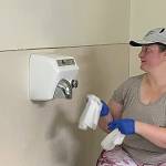 Sequim Gazette photo by Matthew Nash/ Rebecca Tenzythoff with Sequim Community Church, cleans walls after painting a bathroom at the Sequim Boys & Girls Club. She said it was her first time helping with the event and encourages locals to reach out to local organizations and schools to volunteer as they need help year-round.