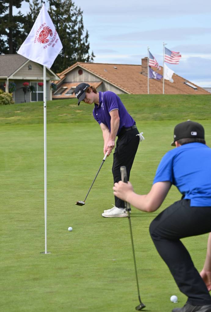 Sequim Gazette photo by Michael Dashiell / Sequims Carter Cronin lines up a putt on the fourth hole at The Cedars at Dungeness, in a league match against Olympic on April 26. Cronin was medalist for the match with a round of 40.