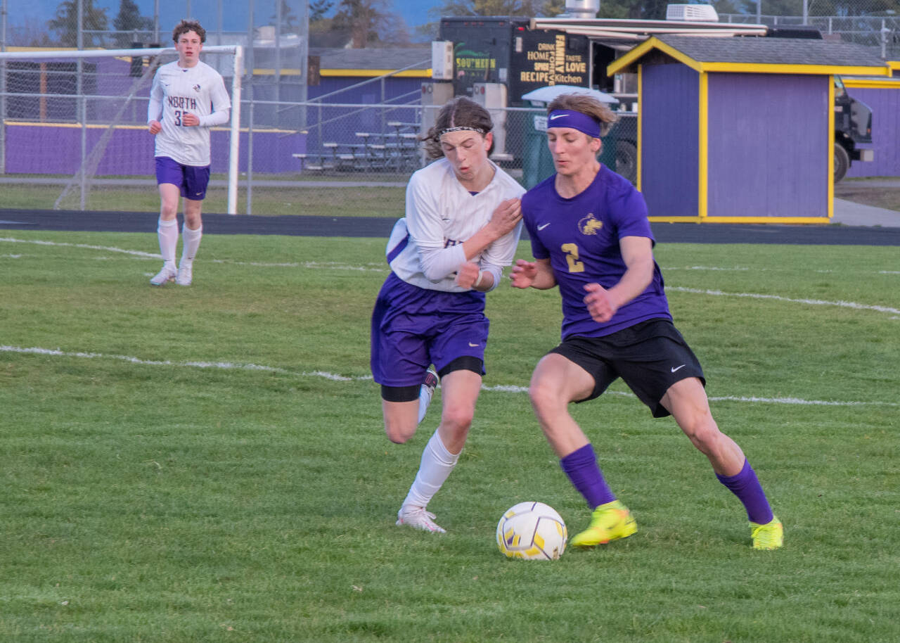Sequim Gazette photo by EmilyMatthiessen / Sequims Nova Barrett, right, battles with North Kitsaps Harper Sabari for the ball in an Olympic League match-up in Sequim on April 25. North Kitsap shut out the Wolves, 2-0.