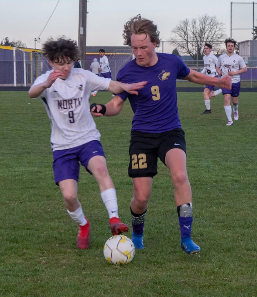 Sequim Gazette photo by EmilyMatthiessen / Sequim midfielder Solas McGruther, right, battles with North Kitsaps Austin Stricklin for the ball in an April 24 Olympic League game in Sequim on April 25. North Kitsap edged the Wolves, 2-0.