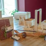 Sequim Gazette photo by Emily Matthiessen / The Goat and the Radish prepares custom charcuterie and packs them in a variety of containers, dictated by customer choice. The snackle box, seen here closed and open, is one of their specialty items. Seen with them are some of the handcrafted wooden tools made by local woodworker Keith Cortner which are sold in the cafes market section.