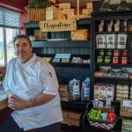 Sequim Gazette photo by Emily Matthiessen / Chef Ted Walker pauses in between orders at The Goat and the Radish, in the Matriotti Center, 261043 US Highway 101 in Carlsborg. Behind him are some of the local products sold in the cafe, which specializes in charcuterie to go and serves 16-inch crepes, salads and sandwiches as well.