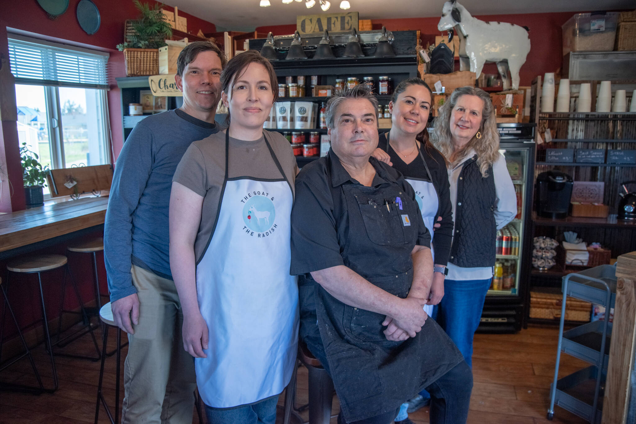 Sequim Gazette photoS by Emily Matthiessen
Chef Ted Walker, sitting, and, from left to right: Joe Manney, Emily Walker, Amy Shea and Ann Walker are the family behind Carlsborgs new eatery, The Goat and the Radish. Not pictured is Sheas husband, Justin, who the family referred to as a carpenter extraordinaire.