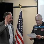 Sequim Gazette photo by Matthew Nash
Fire commissioner Bill Miano, right, swears in appointed commissioner Mike Mingee on May 2 during a meeting of the Clallam County Fire District 3s board of commissioners. Mingee told commissioners in April hes planning to file to run for the position this month.