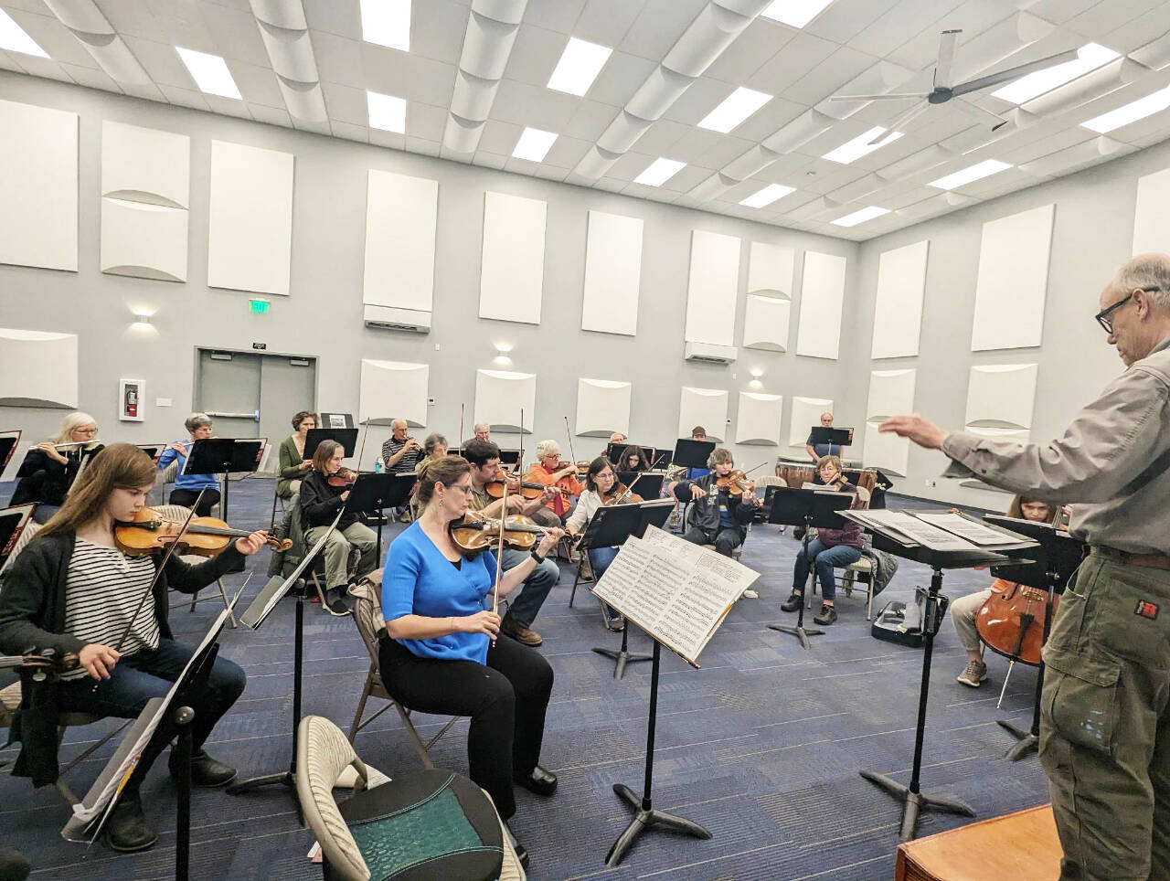 Photo courtesy of Sequim Community Orchestra / Conductor/music director Phil Morgan-Ellis leads a Sequim Community Orchestra rehearsal on April 25 at the Sequim City Band expanded rehearsal hall at the James Center for Performing Arts. The orchestra closes their 11th season with a free concert and bake sale at 7 p.m. on Saturday, May 13, at Trinity United Methodist Church.