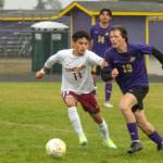 Sequim Gazette photo by Emily Matthiessen / Sequims Finn Braaten, right, advances the ball toward Kingston territory as Buccaneer Anthony Haroz gives chase. Kingston won the May 4 league match-up 2-1 in extra time.