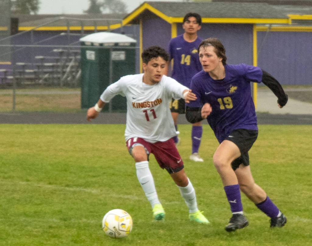 Sequim Gazette photo by Emily Matthiessen / Sequims Finn Braaten, right, advances the ball toward Kingston territory as Buccaneer Anthony Haroz gives chase. Kingston won the May 4 league match-up 2-1 in extra time.