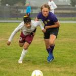 Sequim Gazette photo by Emily Matthiessen / Sequims Solas McGruther, right, and Kingstons Evan Feldbau vie for the ball in a May 4 Olympic League match-up. Kingston edged the Wolves 2-1 in extra time.