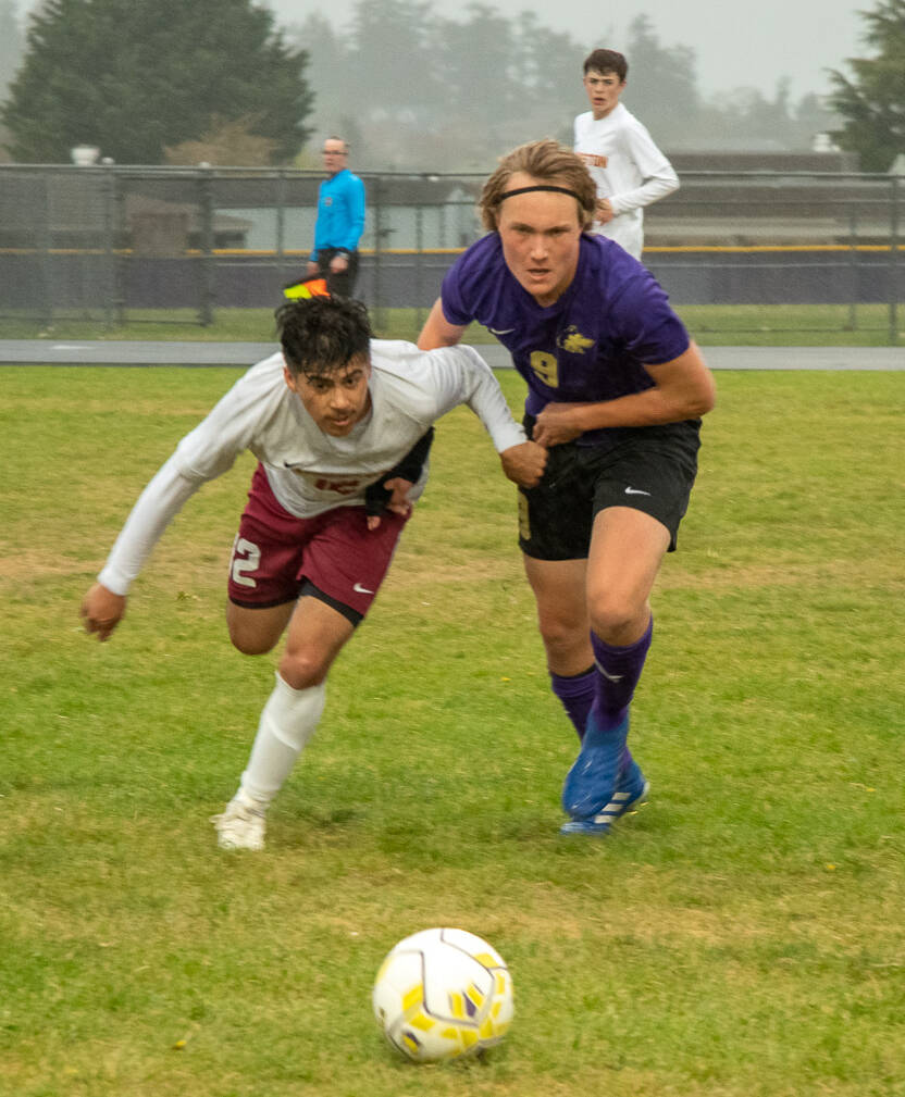Sequim Gazette photo by Emily Matthiessen / Sequims Solas McGruther, right, and Kingstons Evan Feldbau vie for the ball in a May 4 Olympic League match-up. Kingston edged the Wolves 2-1 in extra time.