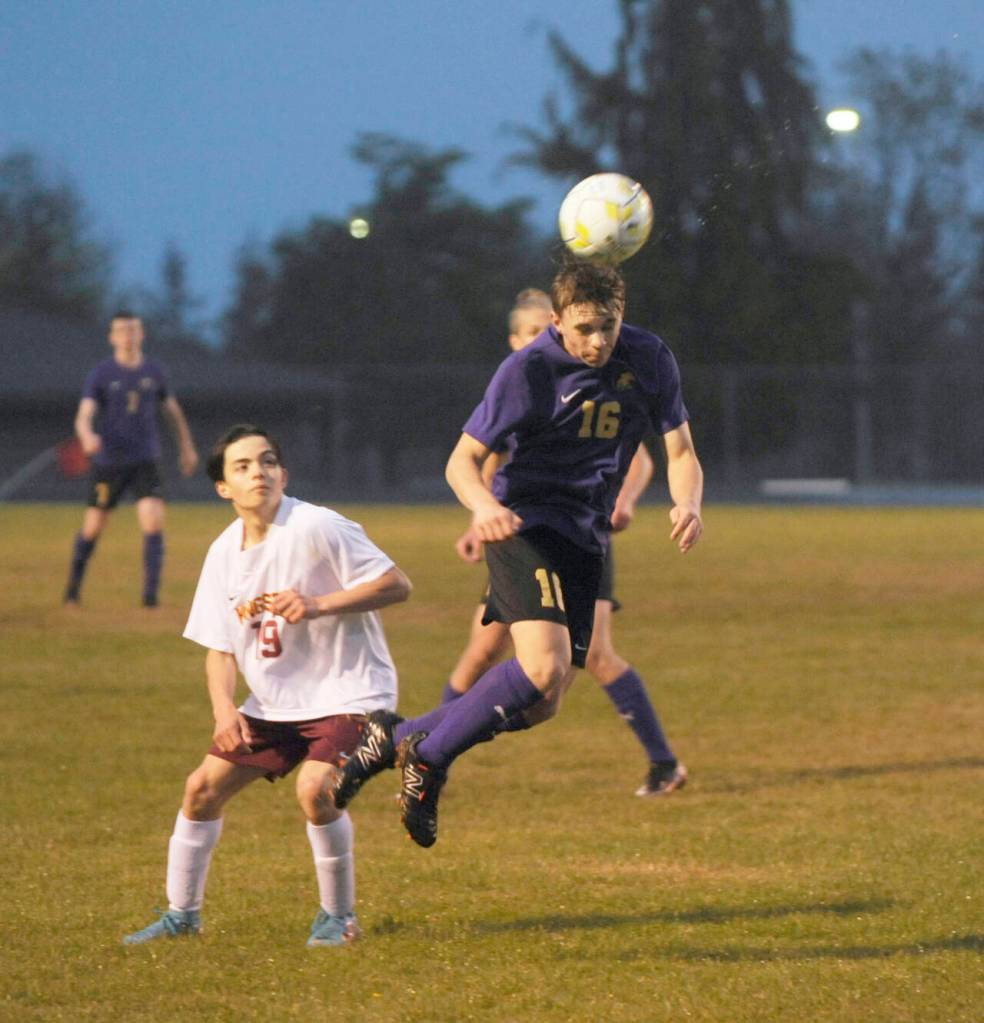 Sequim Gazette photo by Michael Dashiell / Sequims James Mason, right, gets his head on the ball in the second half of a match-up with Kingston on May 4. Looking on is Buccaneer Evan Garcia.