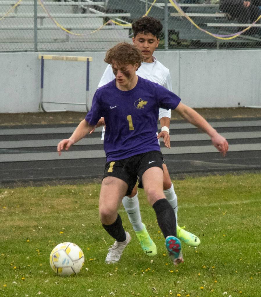 Sequim Gazette photo by Emily Matthiessen / Sequims Keaton King keeps the ball away from Kingstons Anthony Haroz in a May 4 Olympic League game. Kingston edged the Wolves 2-1 in extra time.