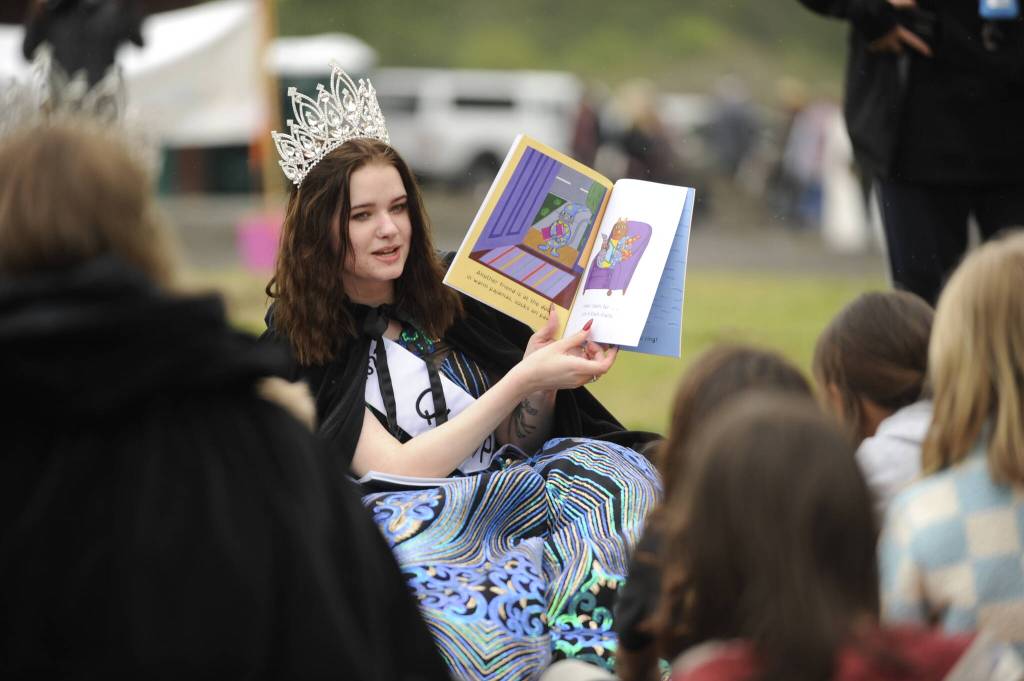 Sequim Gazette photo by Michael Dashiell / With help from the Black Bear Diner bear, Sequim Irrigation Festival queen Pepper Reymond shares stories with youngsters at the Family Fun Day event on May 6.