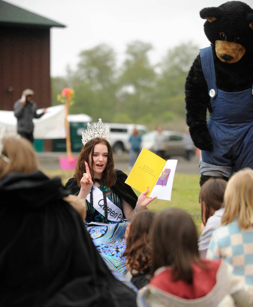 Sequim Gazette photo by Michael Dashiell / With help from the Black Bear Diner bear, Sequim Irrigation Festival queen Pepper Reymond shares stories with youngsters at the Family Fun Day event on May 6.