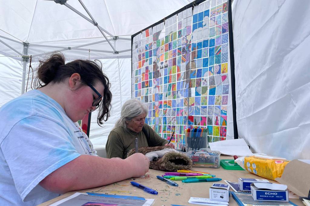 Sequim Gazette photo by Matthew Nash
Abby Blaine, of Port Angeles, left, and Lauren Churchill of Sequim, design their own cards at the Irrigation Festivals booth at the Innovative Arts and Crafts Fair. Each card helps recreate a portion of this years poster designed by Laura Friedkin. The idea was developed by festival volunteer Jean Wyatt, and the cards will likely go up in the Sequim Civic Center in June, organizers said.