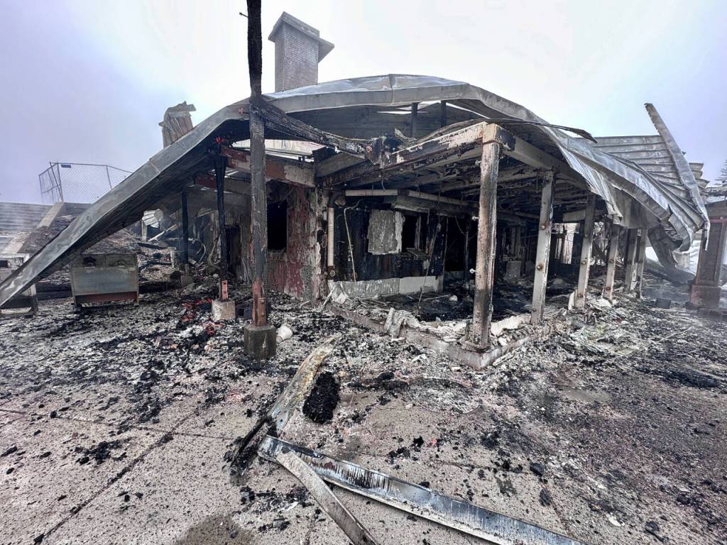 Photo by Jay Cline/Clallam County Fire District 2 / The charred remains of the Olympic National Park Day Lodge, an iconic structure built in the 1950s, are whats left after a fire discovered on May 7 burned it to the ground.