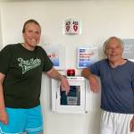Photo courtesy of Peninsula College / Allison Mahaney and Mike Aldrich are pictured near an Automated External Defibrillator (AED) device at Peninsula College. The pair gave CPR to fellow Noon Hoops teammate Bob Lawrence after he collapsed on the court.