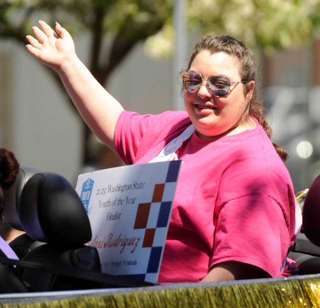 Sequim Gazette photo by Michael Dashiell / Kailani Rodriguez, of Port Angeles, who was selected at the Youth of the Year by the Boys and Girls Clubs of the North Olympic Peninsula and finalist for Washington State Youth of the Year, waves to the Sequim Irrigation Festival Grand Parade on May 13.