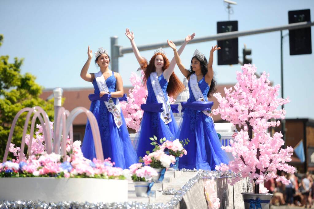 Sequim Gazette photo by Michael Dashiell / Royalty from Capital Lakefair Festival wave to the crowd at the May 13 Sequim Irrigation Festival Grand Parade.