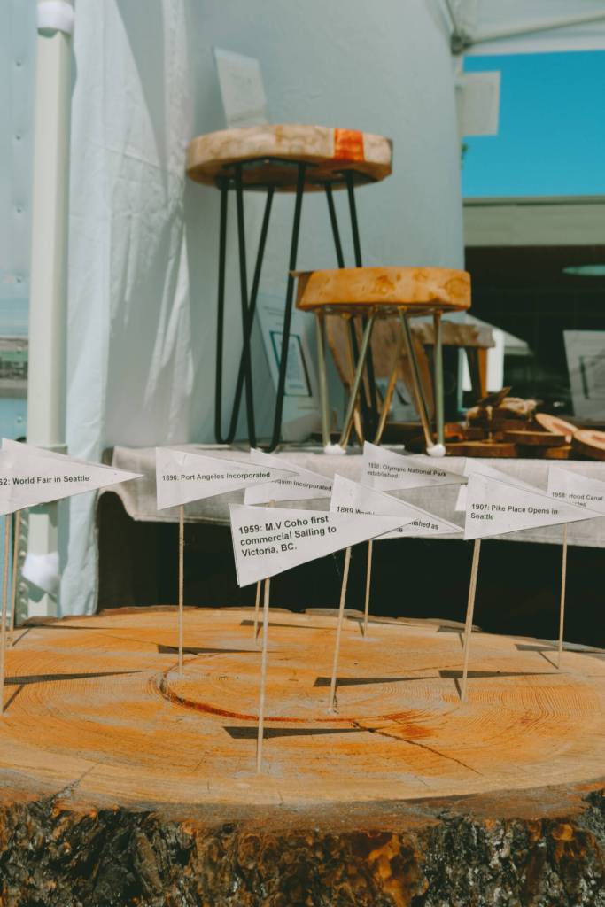 The history of the Olympic Peninsula is mapped onto tree rings from a 200-year-old Douglas Fir that used to stand by Lake Crescent, on display at the Olympic Rounds booth at the Sequim Farmers & Artisans Market.