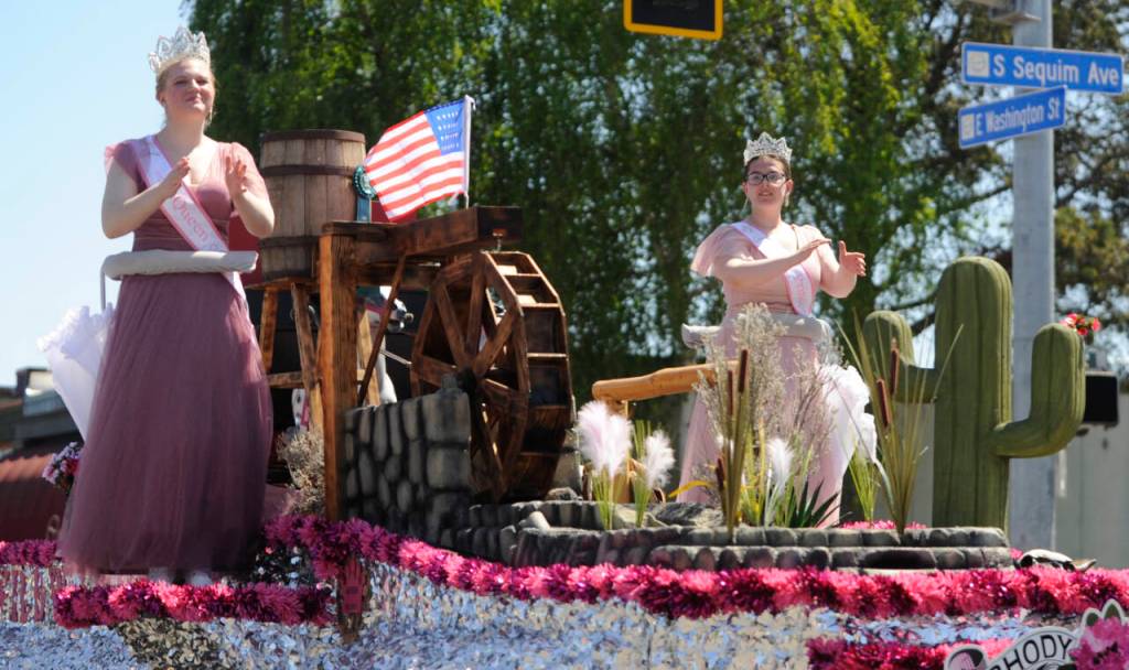 Sequim Gazette file photo by Michael Dashiell / Wild Wild Rhody Festival royalty Melody Douglas, left, and Paige Govia wave to the crowd at the Sequim Irrigation Festival Grand Parade on May 13. The float took home the Presidents Award following the parade.