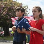 Sequim Gazette photo by Michael Dashiell / Wolfgang Daniel Bowerman and Brooklynn Glavin, students at Olympic Peninsula Academy, help dedicate the schools new flagpole at a special ceremony at the school on May 18.