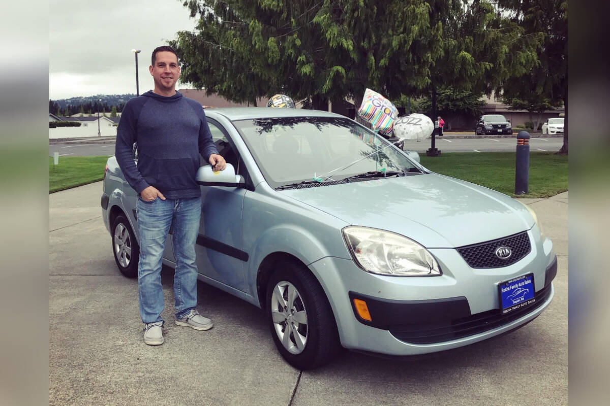 Owner Michael Rocha with a previous years prize vehicle given away by Rocha Family Auto Sales.
