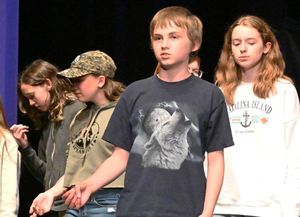 Sequim Gazette photo by Michael Dashiell / In the foreground, Glenn McCarter helps lead a song during a rehearsal for Olympic Peninsula Academys musical comedy, The Nifty Fifties.