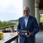 Photo by Jesse Major/Rails-to-Trails Conservancy / Washington state Gov. Jay Inslee poses with the Doppelt Family Rail-Trail Champion Award presented to him by the Rails-to-Trails Conservancy on June 7.