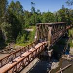 Photo by Jesse Major/Rails-to-Trails Conservancy
Washington state Gov. Jay Inslee, third from left, and his team ride across the bridge at Railroad Bridge Park on the Olympic Discovery Trail on June 7.