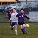 Sequims Colin Feik, right, passes to a teammate in a March 30 Olympic League match-up.