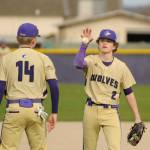 Sequim Gazette photo by Michael Dashiell / Sequim pitcher Zeke Schmadeke, right, gets the ball from third baseman Devyn Dearinger following an out in the third inning of an April 13 league showdown with Port Angeles.
