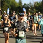 Sequim Gazette photo by Michael Dashiell / Van Onishi, of Seattle, and other runners break from the starting line of the full North Olympic Discovery Marathon in Blyn on June 4.