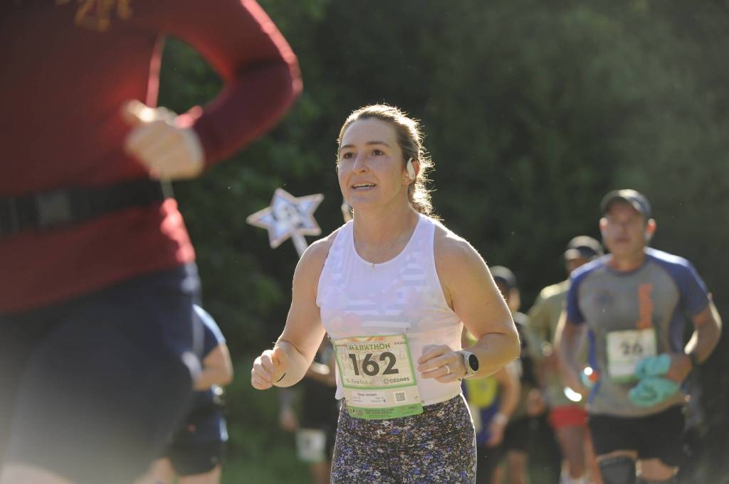 Sequim Gazette photo by Michael Dashiell / Skye Jensen of Port Angeles and other runners in the North Olympic Discovery Marathon reach the outskirts of Sequim on June 4.