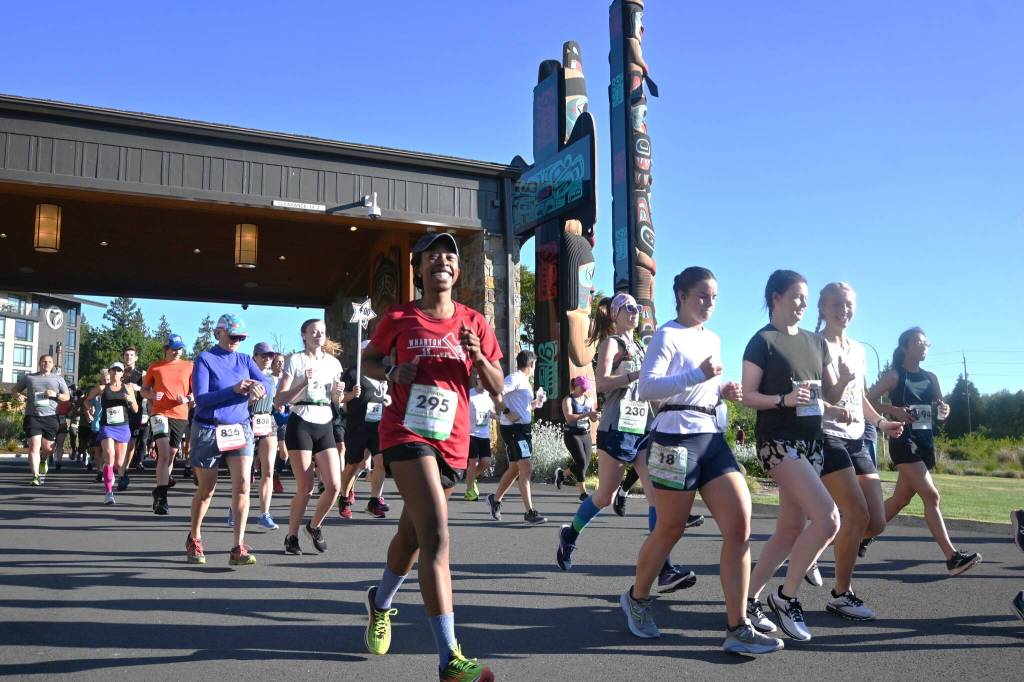 Sequim Gazette photo by Michael Dashiell 
Chanelle Lansley of Seattle is all smiles as she and other full North Olympic Discovery Marathon runners break from the start in Blyn on June 4. See story, more photos on B-5.