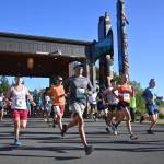 Sequim Gazette photo by Michael Dashiell / Runners break from the starting line of the full North Olympic Discovery Marathon in Blyn on June 4.