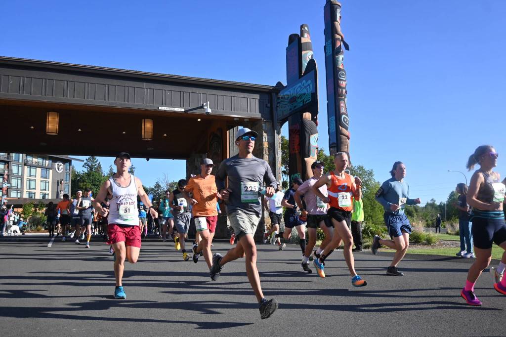Sequim Gazette photo by Michael Dashiell / Runners break from the starting line of the full North Olympic Discovery Marathon in Blyn on June 4.